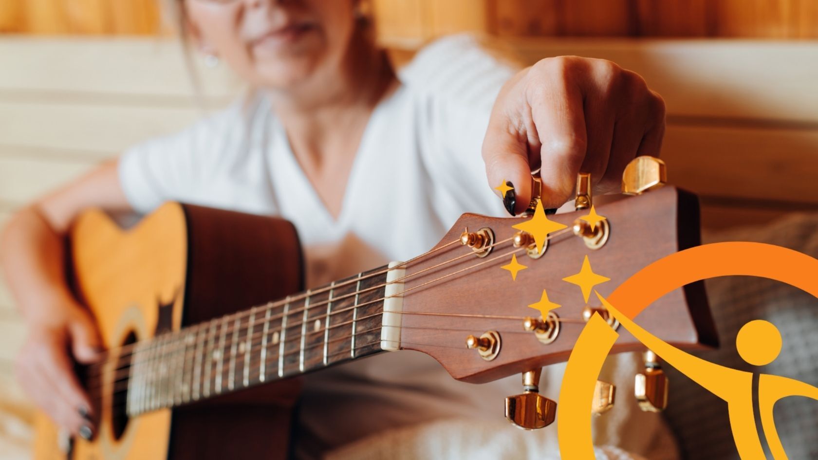 older person tuning a guitar